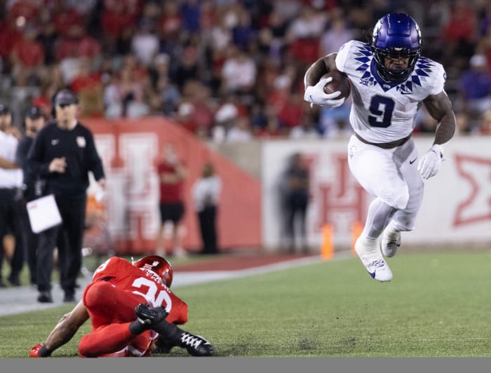 TCU Horned Frogs running back Emani Bailey (9) is tripped by Houston Cougars linebacker Treylin Payne (29) in the second half at TDECU